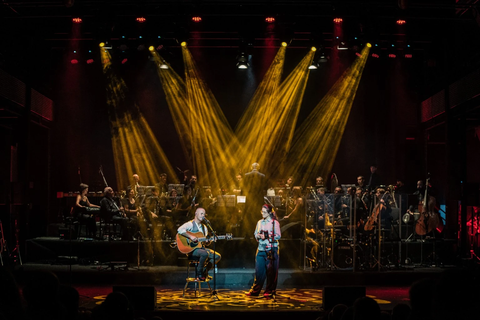 O encontro musical sob a iluminação do palco.